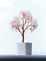 Soft Hold rose quartz crystal tree with copper wire branches in a white pot