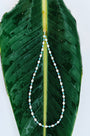 Fine Moonline Necklace with multitone freshwater pearls arranged on a green leaf