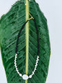 Still Point Necklace with polished black agate and a sculptural freshwater pearl focal, full view