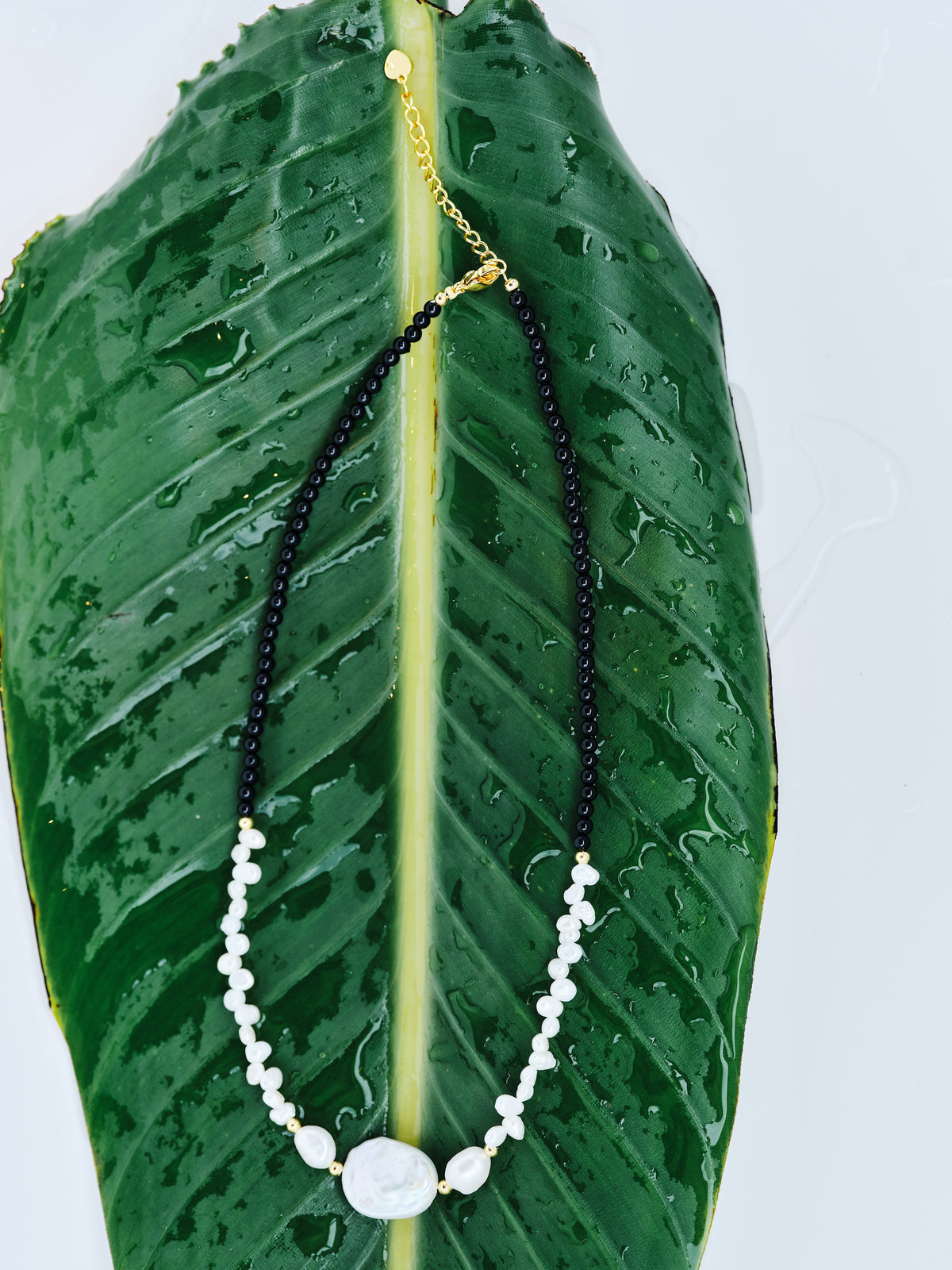 Still Point Necklace with polished black agate and a sculptural freshwater pearl focal, full view
