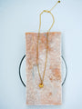 Golden Ingot Chain Necklace in 24K gold-plated copper with a small yuanbao pendant on pale stone.