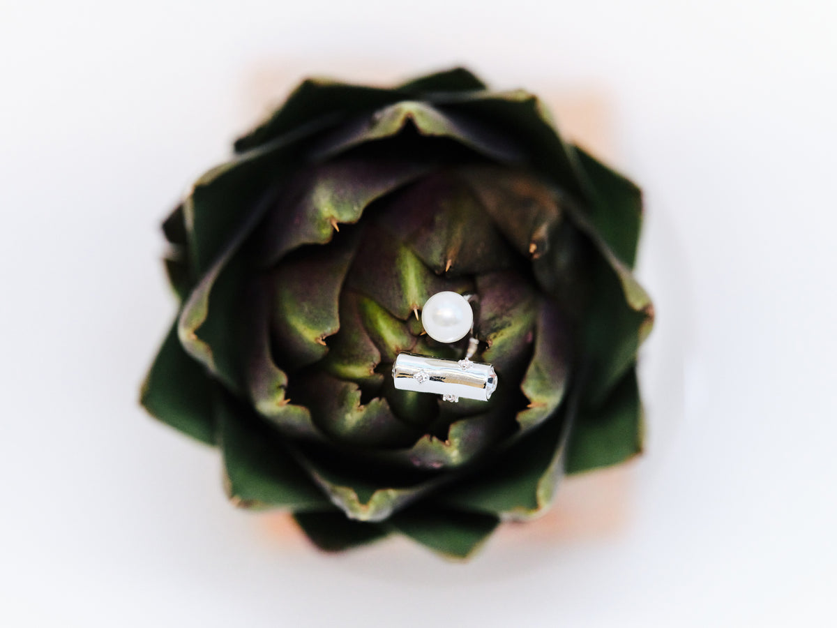 Silver-tone geometric bar and freshwater pearl open ring displayed on an artichoke